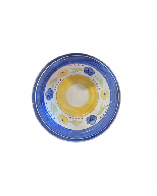 A round ceramic bowl with a hand-painted design featuring a yellow center, blue floral accents, and a blue rim.