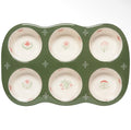 A six-piece ceramic muffin tin with a dark green base and cream-colored bowls decorated with delicate pink and green floral motifs.