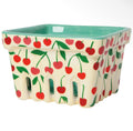 A square ceramic basket with a cream-colored exterior decorated with a red cherry and green leaf pattern, featuring a light green interior.